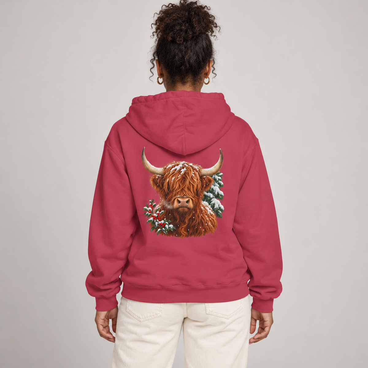 Winter Highland Cow hoodie in Crimson worn, highland cow with holly and snowy pine