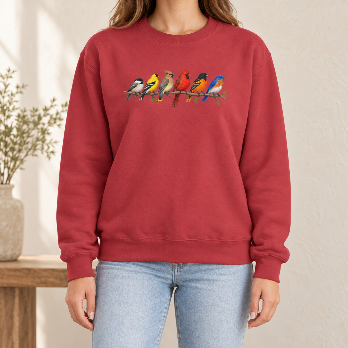 Colorful Birds on Branches sweatshirt in Crimson — six painted songbirds on one branch: chickadee, goldfinch, cedar waxwing, northern cardinal, Baltimore oriole and eastern bluebird, on a garment-dyed Comfort Colors crewneck