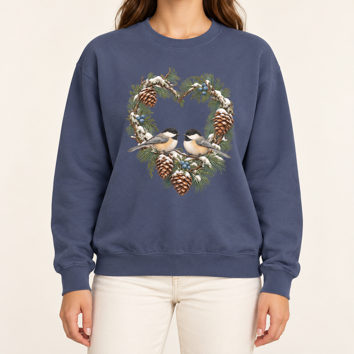 Chickadee heart wreath sweatshirt in Denim – a pair of chickadees on a snowy pine heart wreath with pinecones, printed large on the chest of a Comfort Colors crewneck