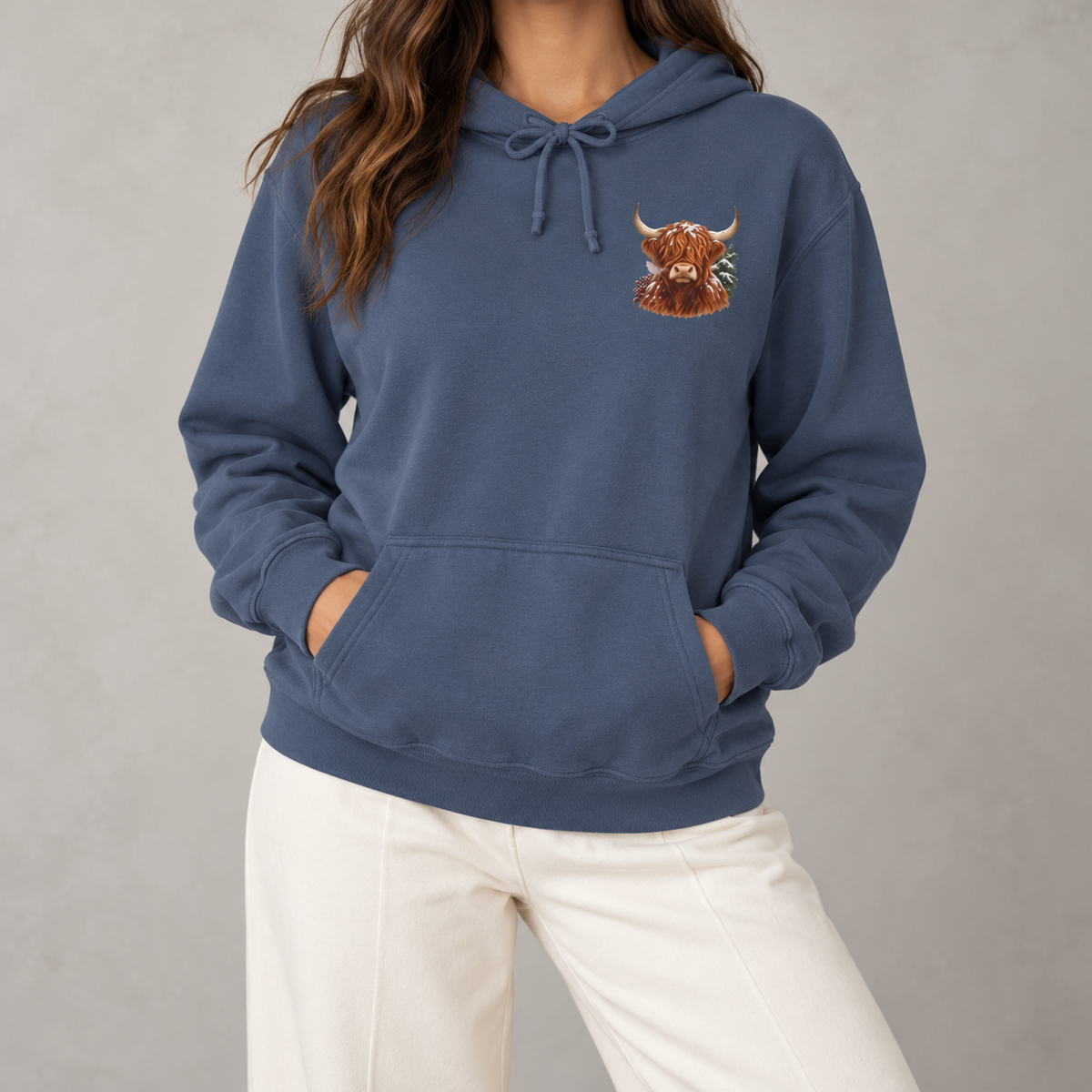 Winter Highland Cow hoodie in Denim worn, front view with the small highland cow crest on the left chest