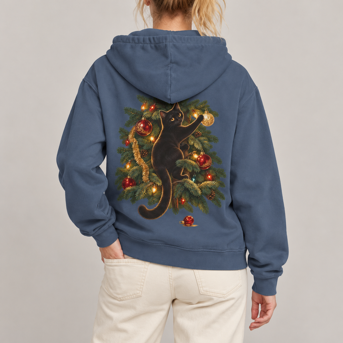 Black Cat Christmas hoodie in Denim worn, back view with the cat climbing the Christmas tree