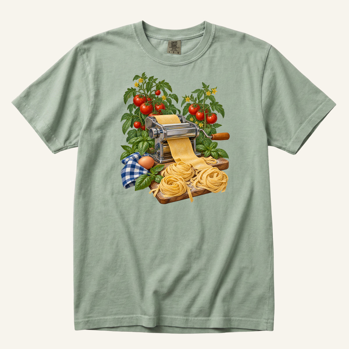 Dinner Takes a Little Longer handmade pasta t-shirt in Bay, a muted dusty blue-green — vintage pasta machine with fresh pasta, tomatoes and basil, garment-dyed Comfort Colors 1717 tee