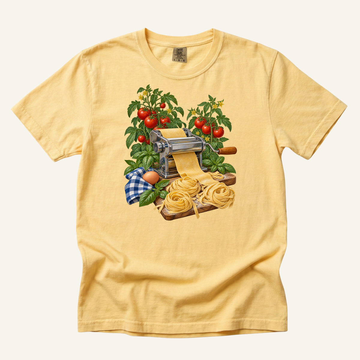 Dinner Takes a Little Longer handmade pasta t-shirt in Butter, a soft pale yellow — vintage pasta machine with fresh pasta, tomatoes and basil, garment-dyed Comfort Colors 1717 tee