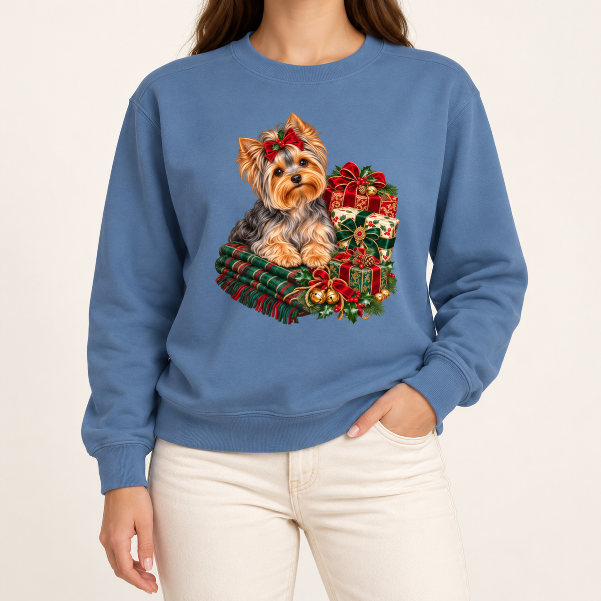 Yorkie Christmas sweatshirt – a Yorkshire terrier with a red bow on a tartan blanket beside wrapped Christmas presents, printed large on the chest of a Comfort Colors crewneck