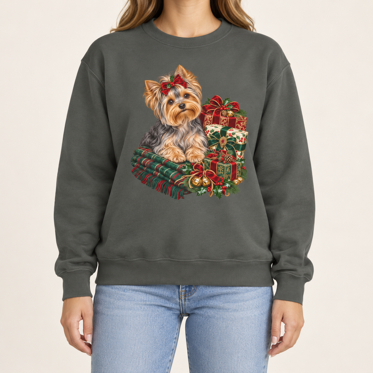 Yorkie Christmas sweatshirt – a Yorkshire terrier with a red bow on a tartan blanket beside wrapped Christmas presents, printed large on the chest of a Comfort Colors crewneck