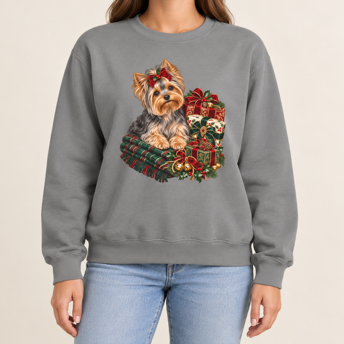 Yorkie Christmas sweatshirt – a Yorkshire terrier with a red bow on a tartan blanket beside wrapped Christmas presents, printed large on the chest of a Comfort Colors crewneck