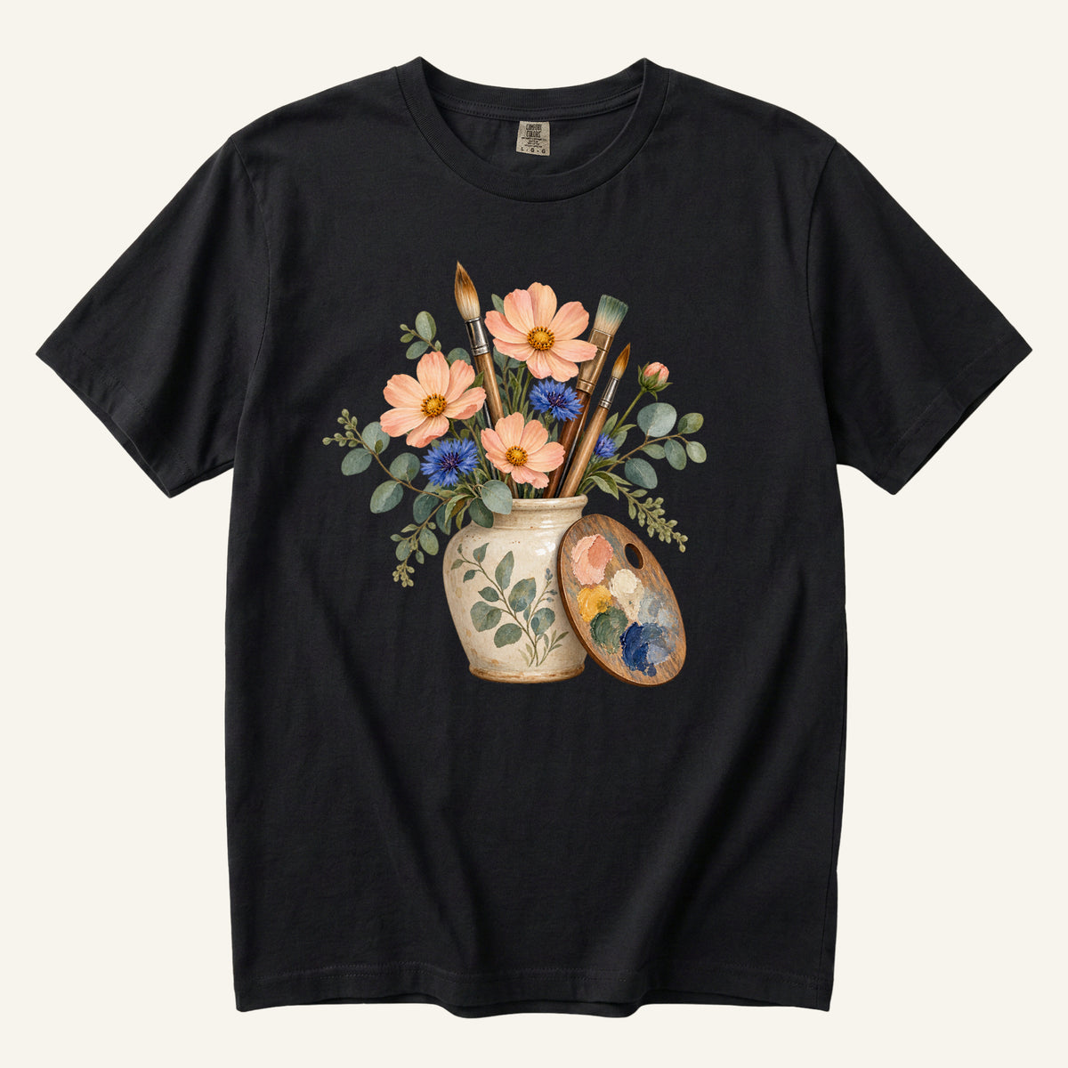 Floral Artist T-Shirt in Black — vintage paintbrushes and a palette among peach cosmos and cornflowers