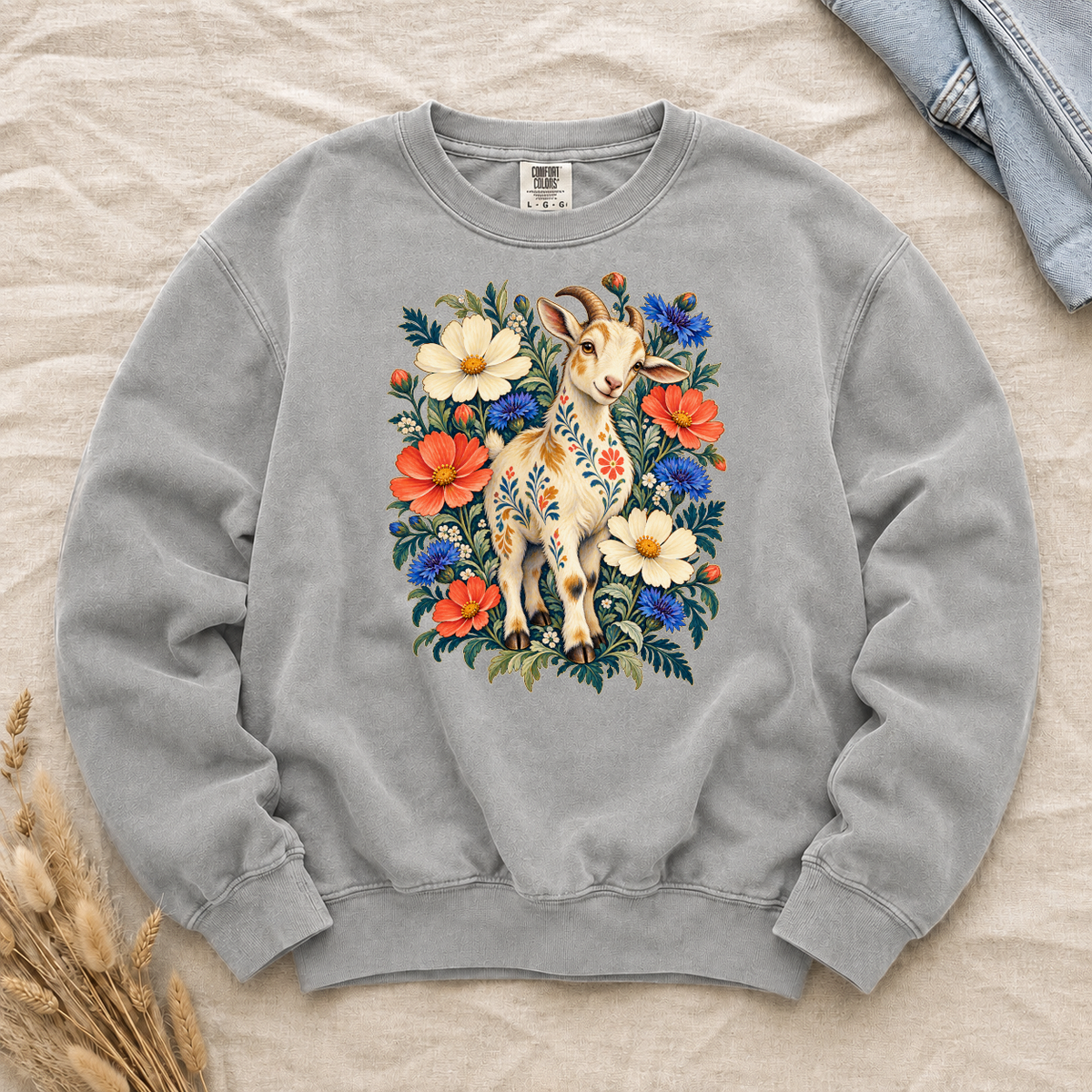 Folk-art goat patterned with flowers among coral and blue blooms on a Grey Comfort Colors crewneck sweatshirt