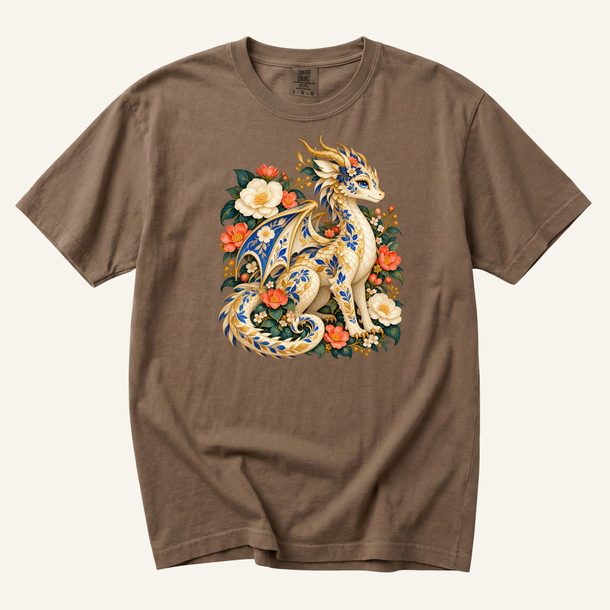 The Garden Was Her Gold floral dragon t-shirt in Espresso, a cream-and-gold dragon patterned with blue botanical ornament like painted porcelain, seated among coral-red flowers, ivory blossoms and deep green foliage