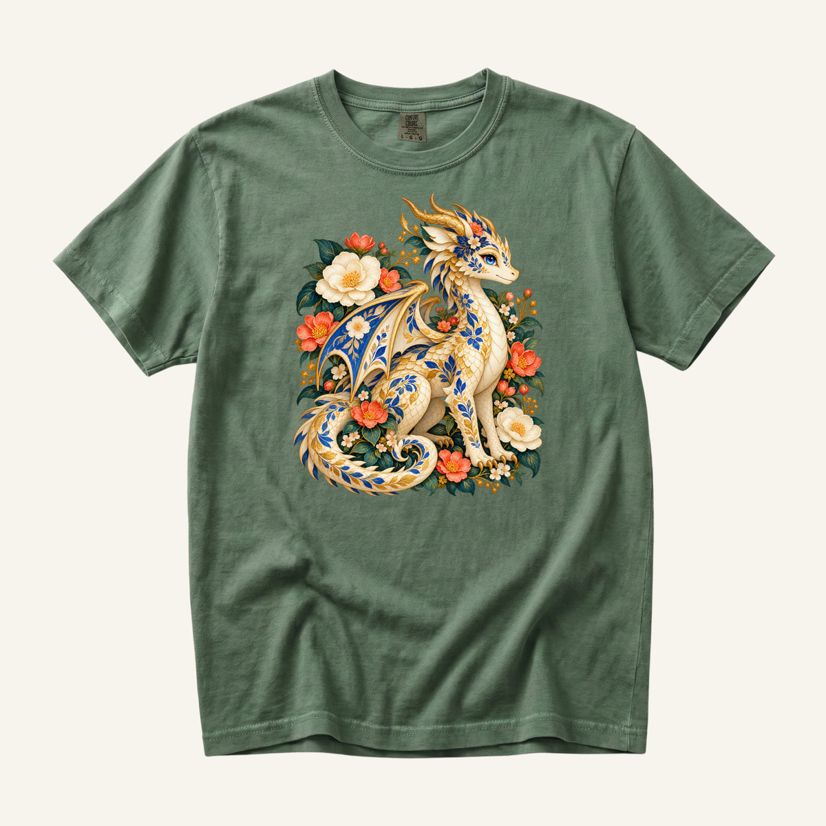 The Garden Was Her Gold floral dragon t-shirt in Moss, a cream-and-gold dragon patterned with blue botanical ornament like painted porcelain, seated among coral-red flowers, ivory blossoms and deep green foliage