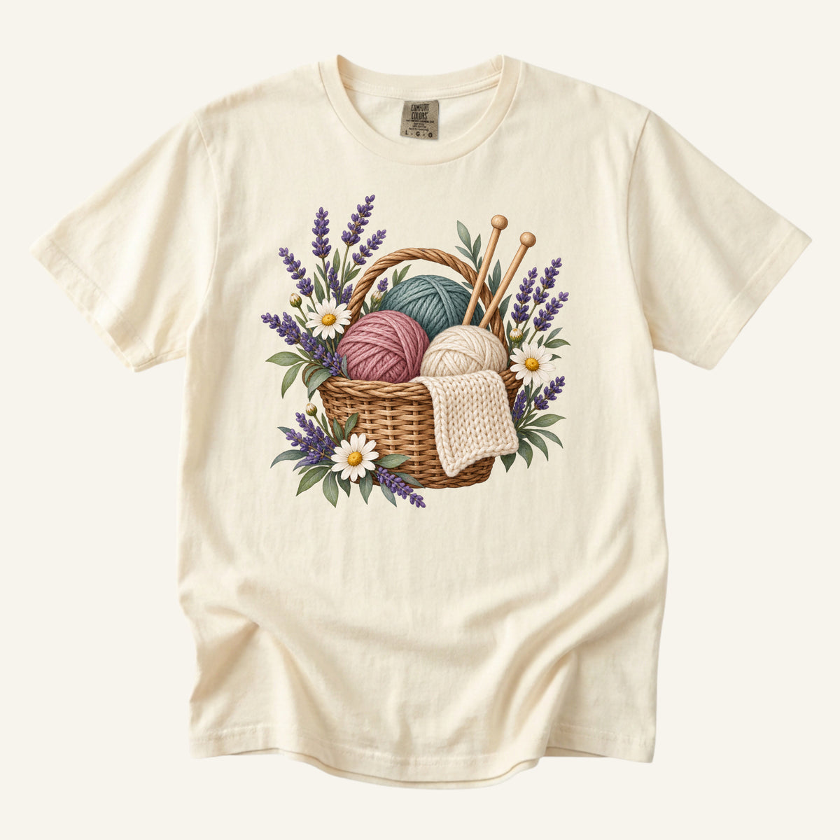Floral Knitting T-Shirt in Ivory — a yarn basket with wooden needles, lavender and white daisies