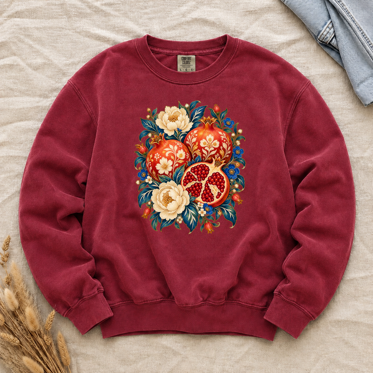 Folk-art pomegranates and cream blossoms printed on a Crimson red Comfort Colors crewneck sweatshirt