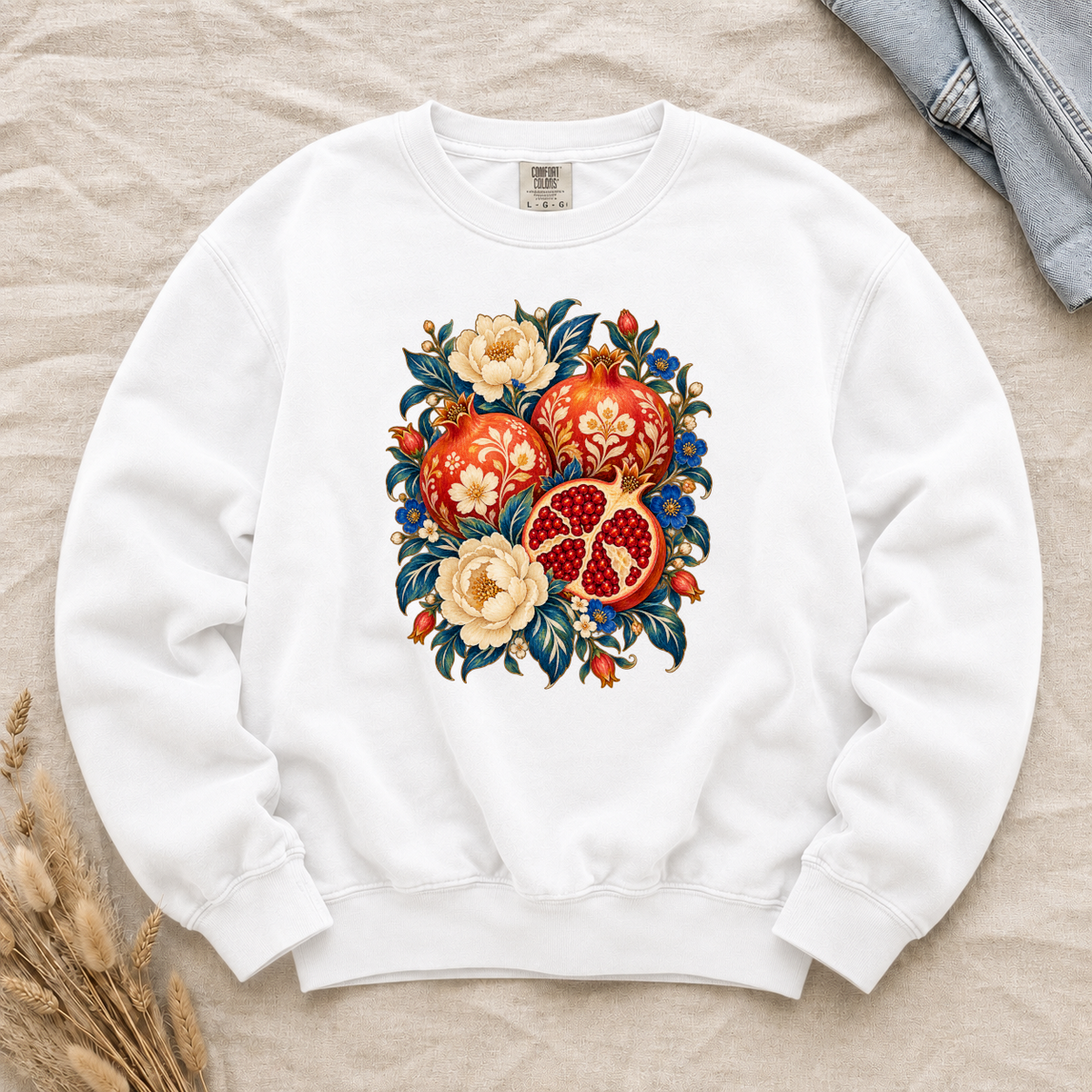 Folk-art pomegranates and cream blossoms printed on a White Comfort Colors crewneck sweatshirt