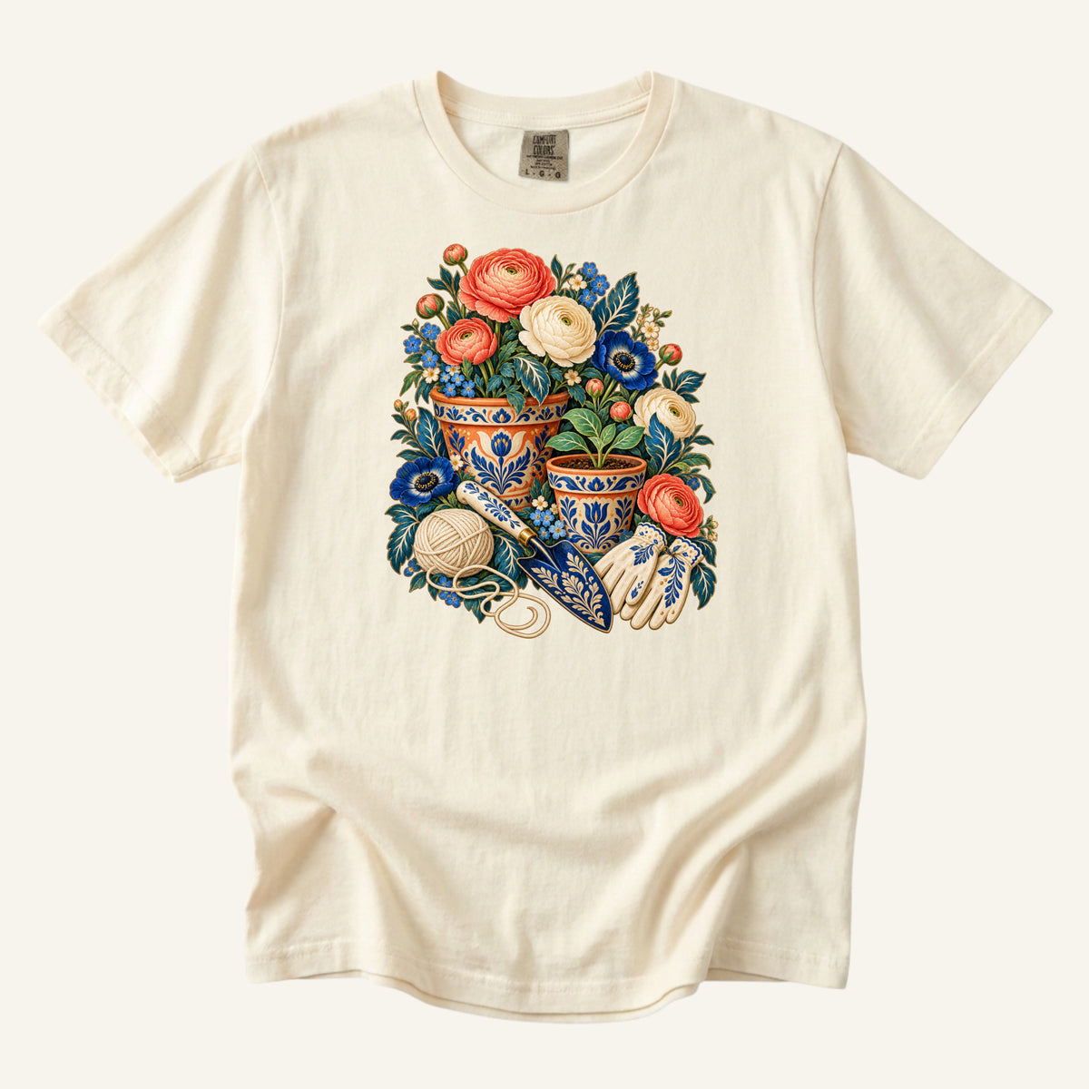Folk Art Garden Pots T-Shirt in Ivory — ornate blue-and-gold garden pots with coral and cream flowers, gloves, trowel and twine below
