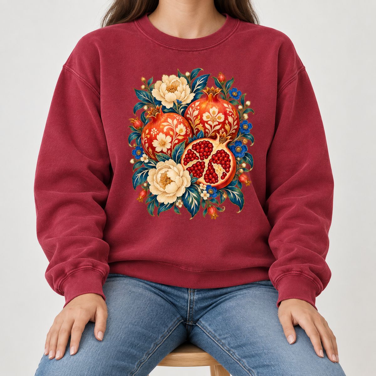 Floral pomegranate sweatshirt shown worn, detail of the cream blossoms and blue-green foliage