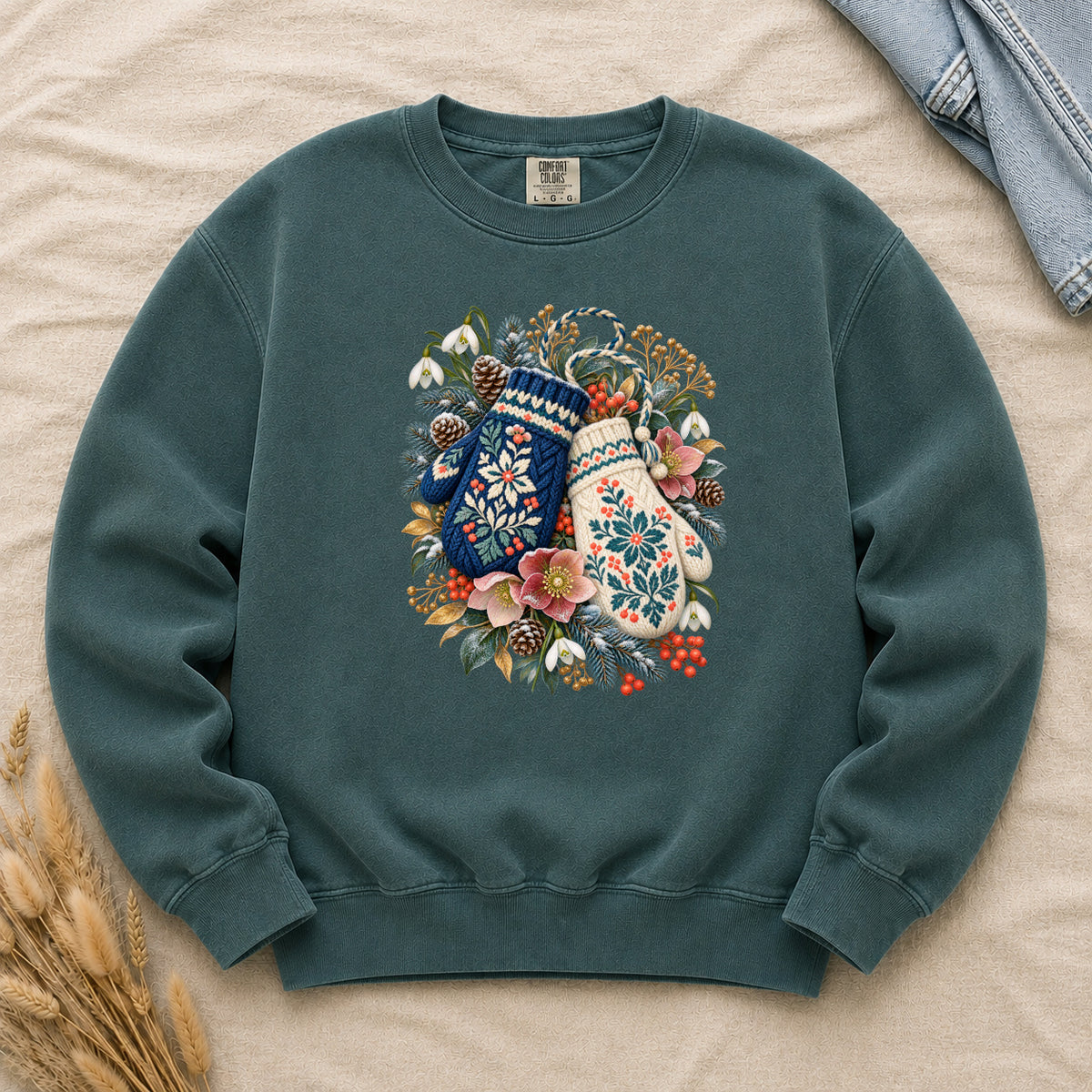 Floral Winter Mittens Sweatshirt in Blue Spruce — the dark colorway, deep forest green, with a deep navy and a cream mitten in a winter bouquet of evergreen, pinecones and berries