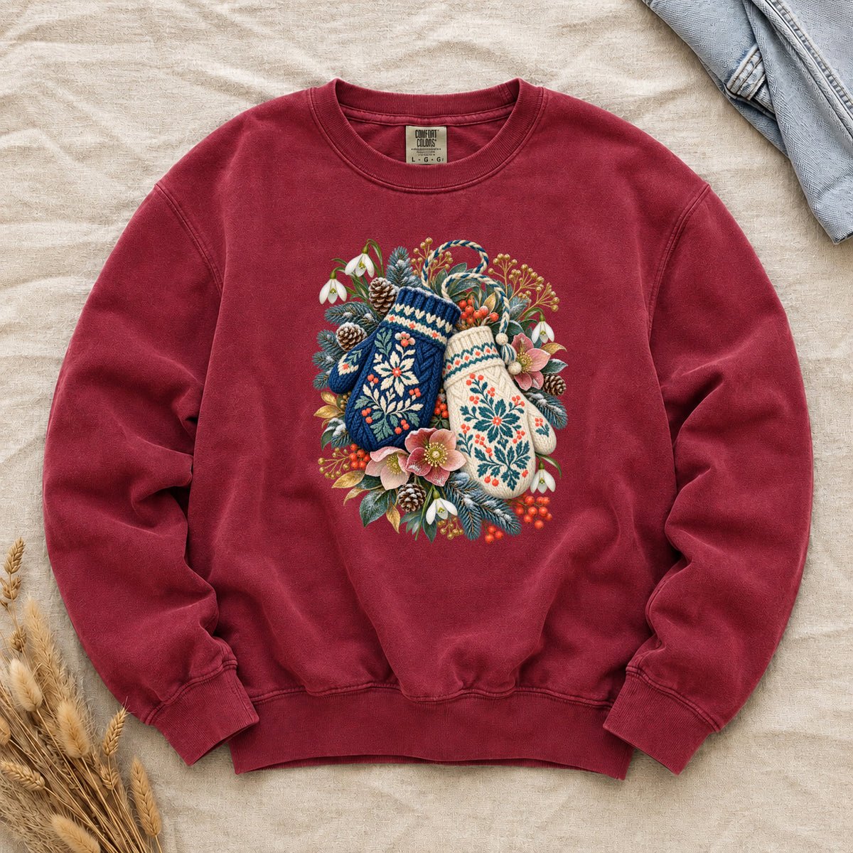 Floral Winter Mittens Sweatshirt in Crimson — deep festive red, with a deep navy and a cream mitten in a winter bouquet of evergreen, pinecones and berries