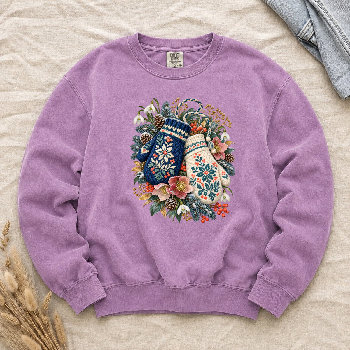 Floral Winter Mittens Sweatshirt in Orchid — soft lilac, with a deep navy and a cream mitten in a winter bouquet of evergreen, pinecones and berries