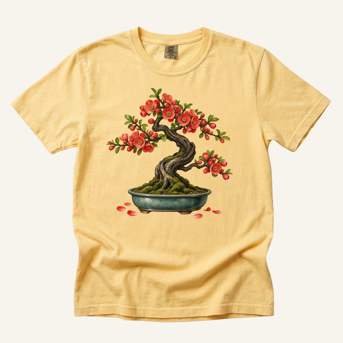 Flowering Bonsai Tree T-Shirt in Butter — a warm backdrop for the red blossoms and moss