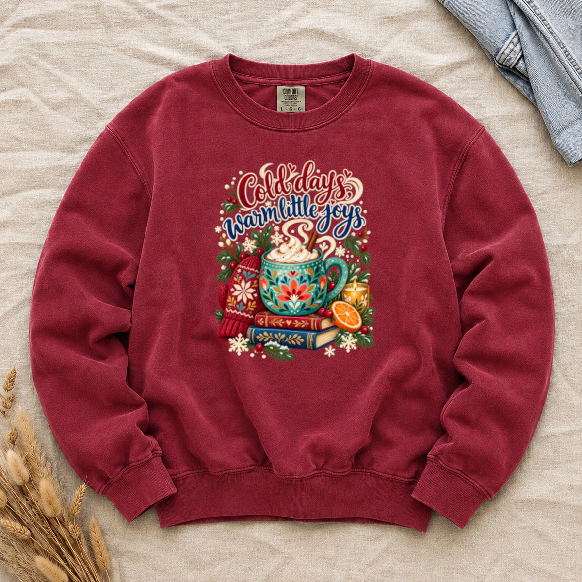 Cocoa and books winter sweatshirt in Crimson, a deep red garment-dyed Comfort Colors crewneck with the cozy winter still life printed on the chest