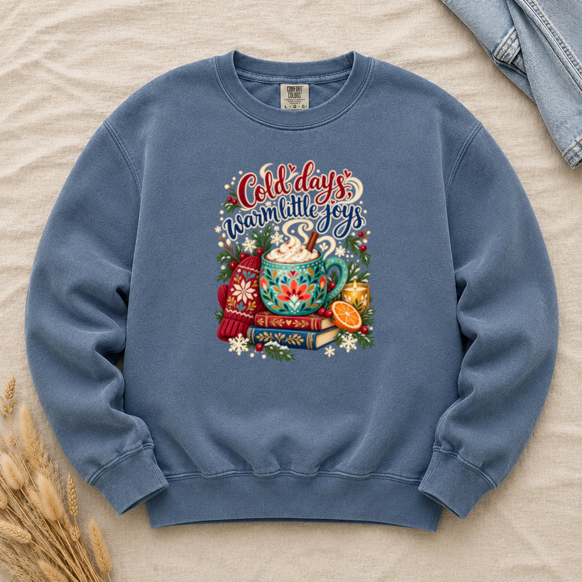 Cocoa and books winter sweatshirt in Denim, a washed mid-blue garment-dyed Comfort Colors crewneck with the cozy winter still life printed on the chest