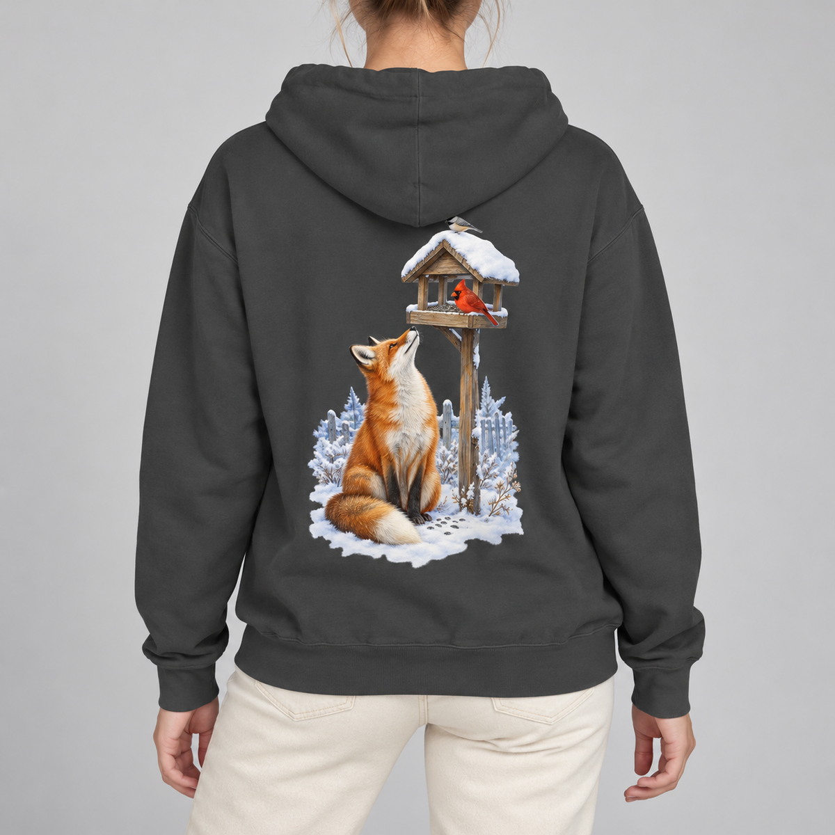 Beneath the Feeder hoodie worn, back view of the winter fox and cardinal print