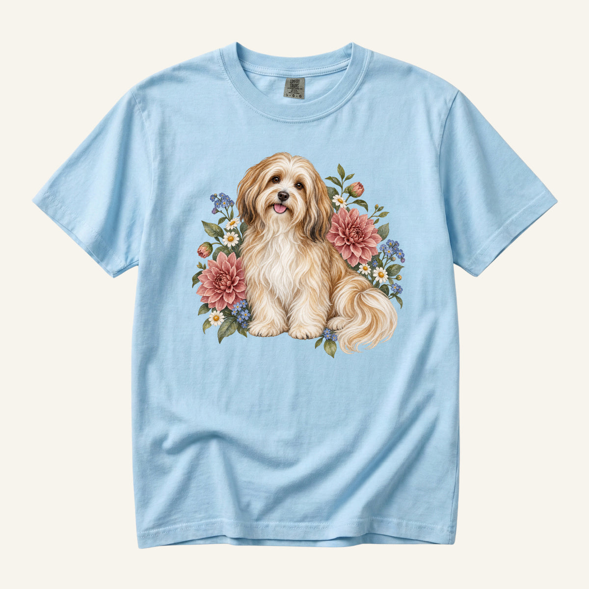 Havanese Dog T-Shirt in Chambray — a cream-and-gold Havanese among dusty-pink dahlias and forget-me-nots