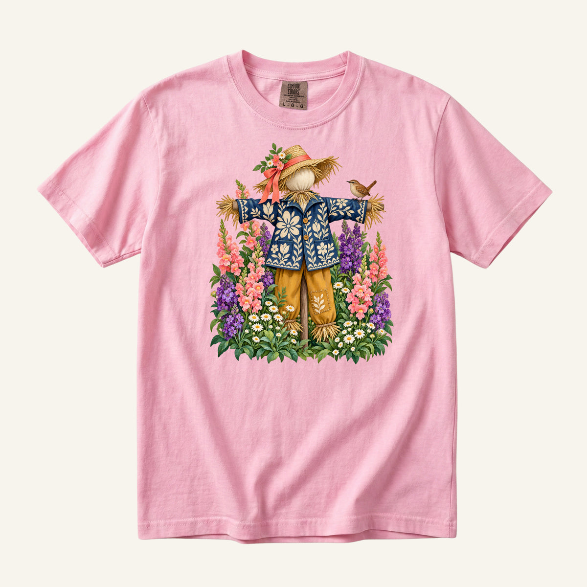 He Let Them Stay T-Shirt in Blossom — a soft pink complementing the garden blooms and the coral hat ribbon