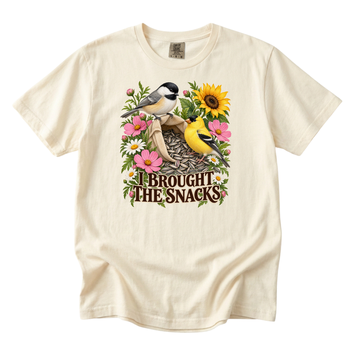 I Brought the Snacks tee in Ivory, a chickadee and goldfinch at a bag of sunflower seeds with garden flowers