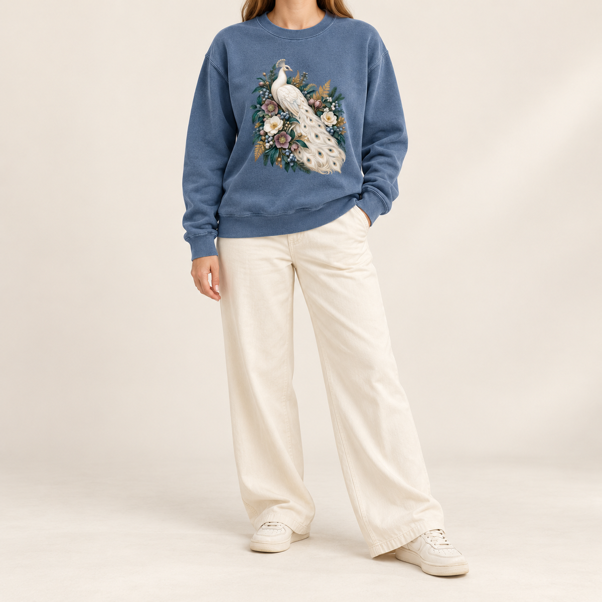 Peacock and floral design on a brushed fleece interior crewneck, printed and not embroidered — an ivory peacock with a long curving tail among cream and purple flowers and deep green leaves