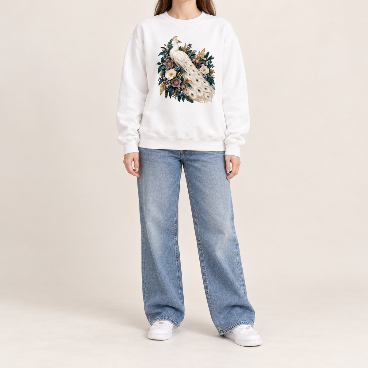 Ivory peacock crewneck with 1x1 ribbed collar, cuffs and waistband, no hood and no front pocket — an ivory peacock with a long curving tail among cream and purple flowers and deep green leaves