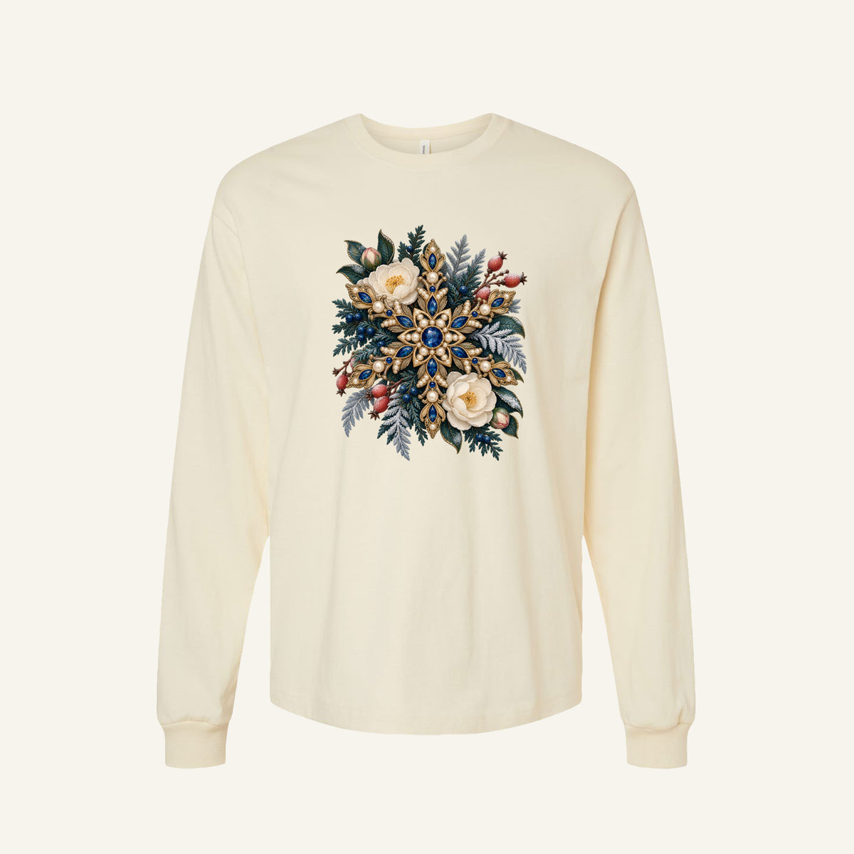 Jeweled Snowflake and Winter Florals Long Sleeve Tee in Natural — an ornate golden snowflake set with deep blue gemstones and pearl-like details, among cream flowers, pink buds, red berries and frosted evergreen branches