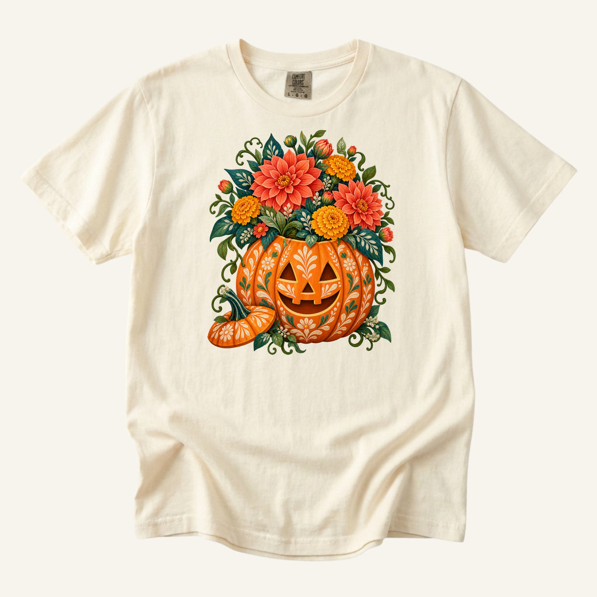 Floral jack-o'-lantern filled with coral and golden flowers on an Ivory Comfort Colors t-shirt