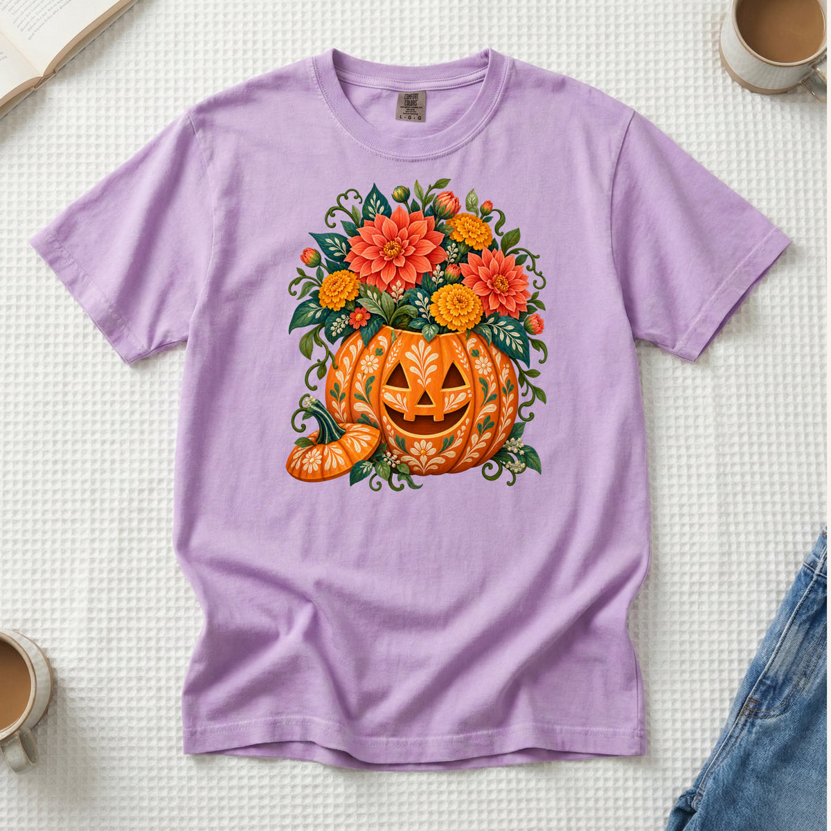 Floral jack-o'-lantern filled with coral and golden flowers on an Orchid purple Comfort Colors t-shirt