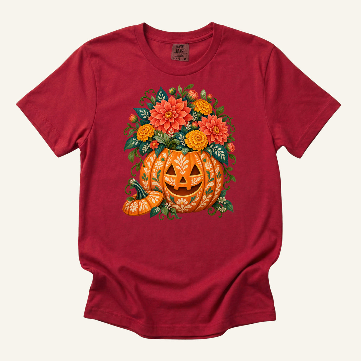 Floral jack-o'-lantern filled with coral and golden flowers on a Red Comfort Colors t-shirt
