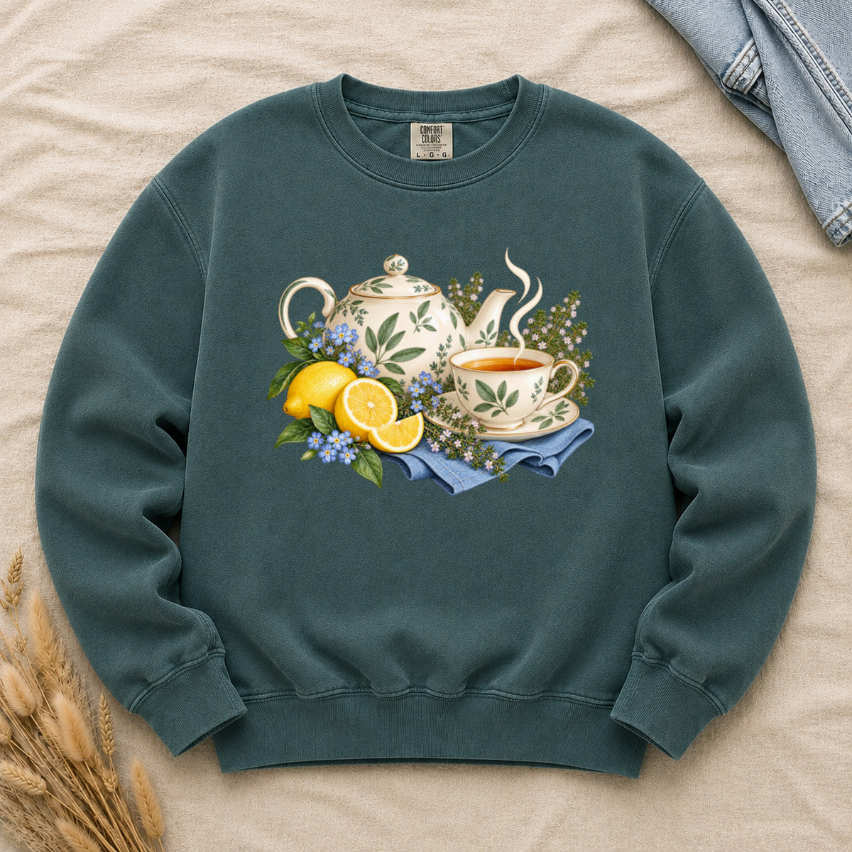 Let the Tea Steep sweatshirt in Blue Spruce, a cream teapot and teacup with golden lemons and blue flowers
