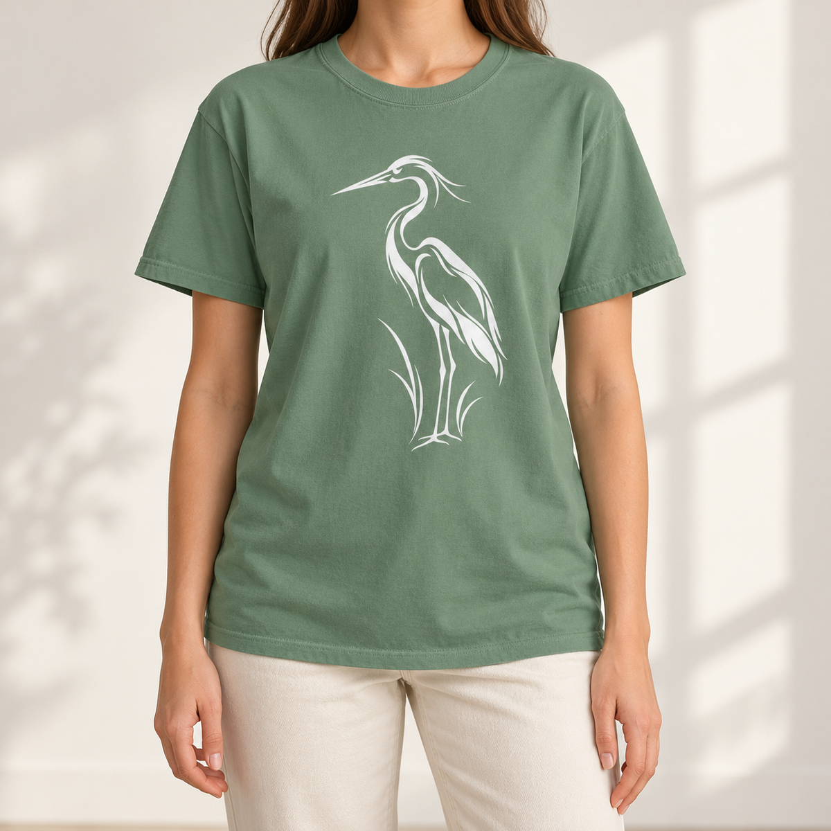 Flowing Great Blue Heron T-Shirt in Light Green — white line-art heron on a garment-dyed Comfort Colors tee