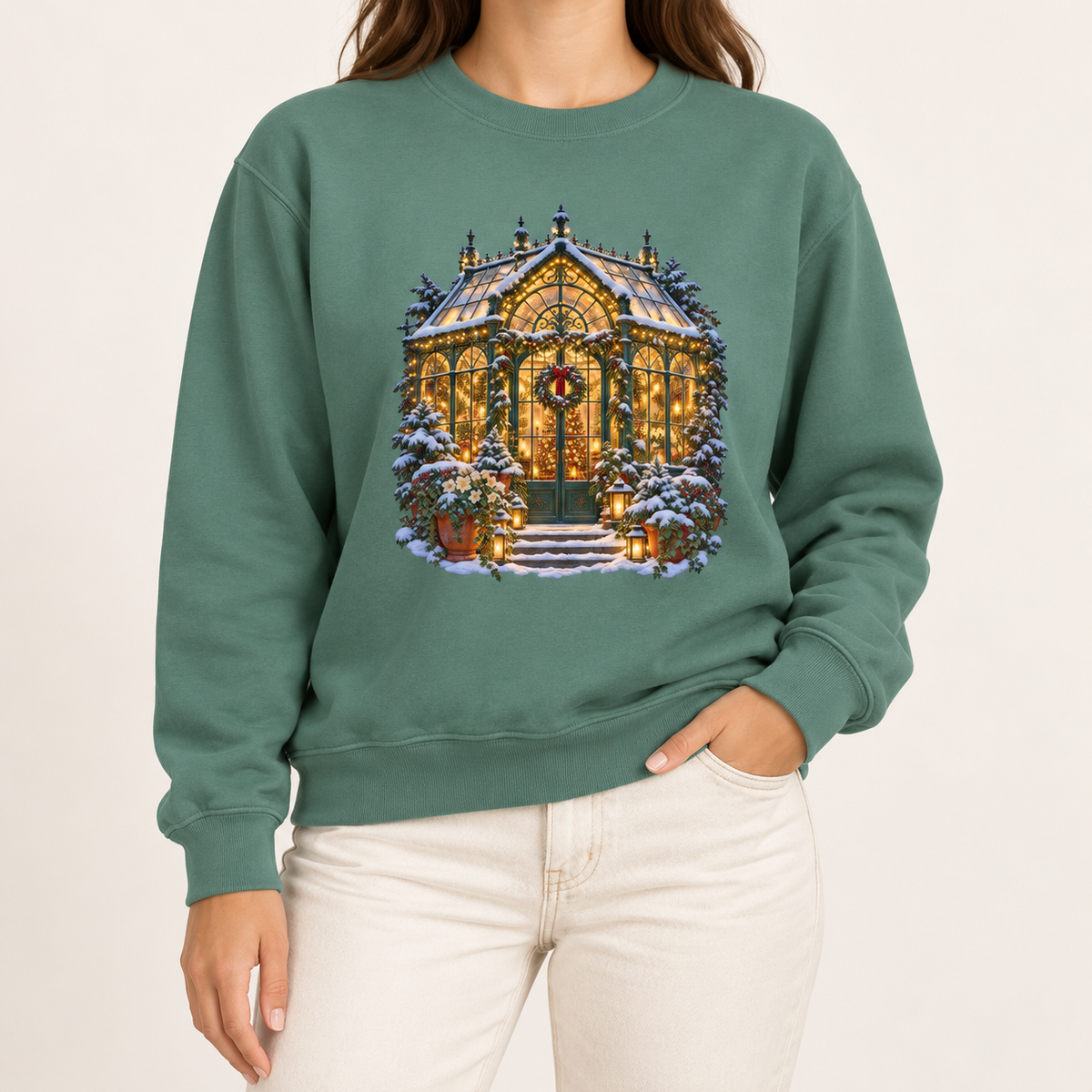 Christmas greenhouse sweatshirt in Light Green: a snowy Victorian conservatory glowing with warm lights on a soft sage garment-dyed Comfort Colors crewneck