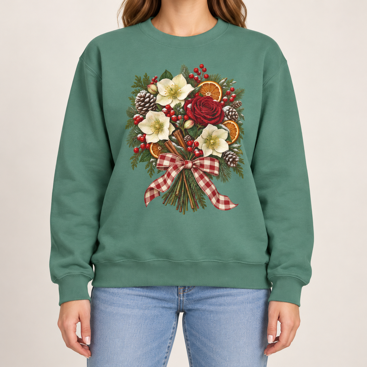 Winter bouquet sweatshirt in Light Green – cream hellebores, a red rose, dried orange slices, cinnamon and pinecones tied with a red gingham bow, printed large on the chest of a Comfort Colors crewneck