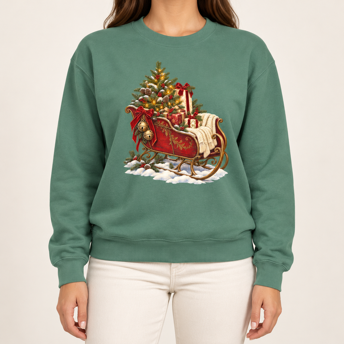 Vintage Christmas sleigh sweatshirt in Light Green – a cranberry-red sleigh with gold trim heaped with fresh-cut fir and hung with golden bells, printed large on the chest of a Comfort Colors crewneck