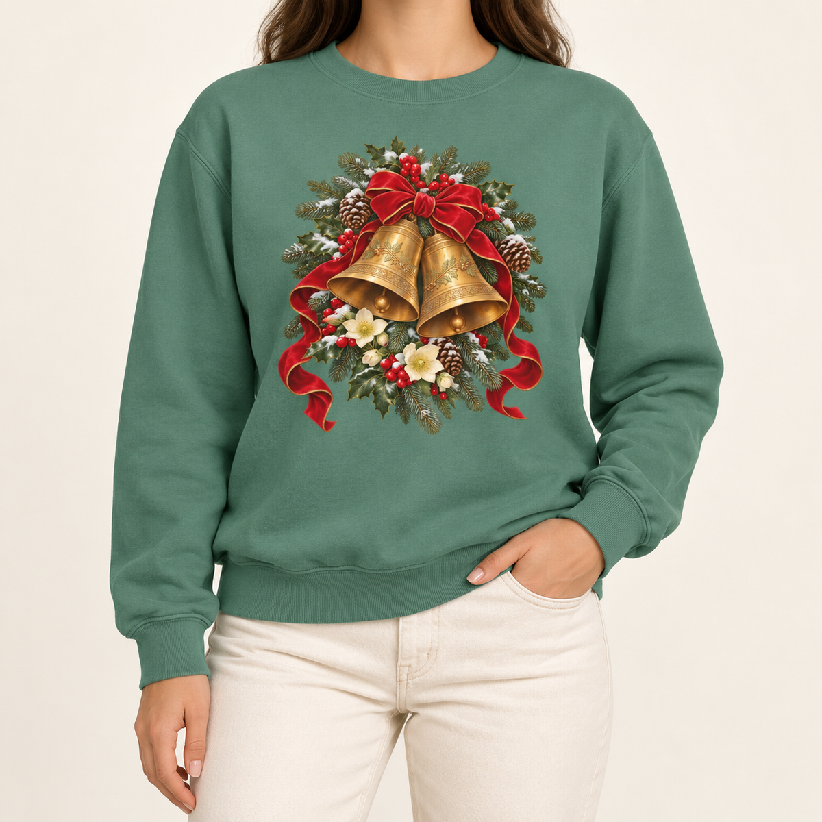 Vintage Christmas bells sweatshirt in Light Green – two golden bells with a red velvet bow among snowy pine, holly, pinecones and hellebores, printed large on the chest of a Comfort Colors crewneck