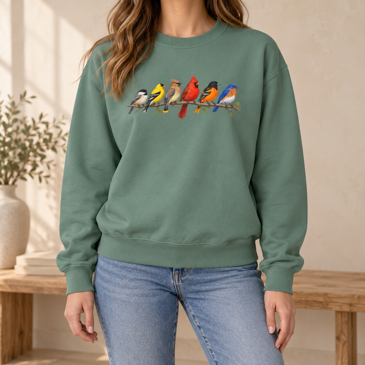 Colorful Birds on Branches sweatshirt in Light Green — six painted songbirds on one branch: chickadee, goldfinch, cedar waxwing, northern cardinal, Baltimore oriole and eastern bluebird, on a garment-dyed Comfort Colors crewneck