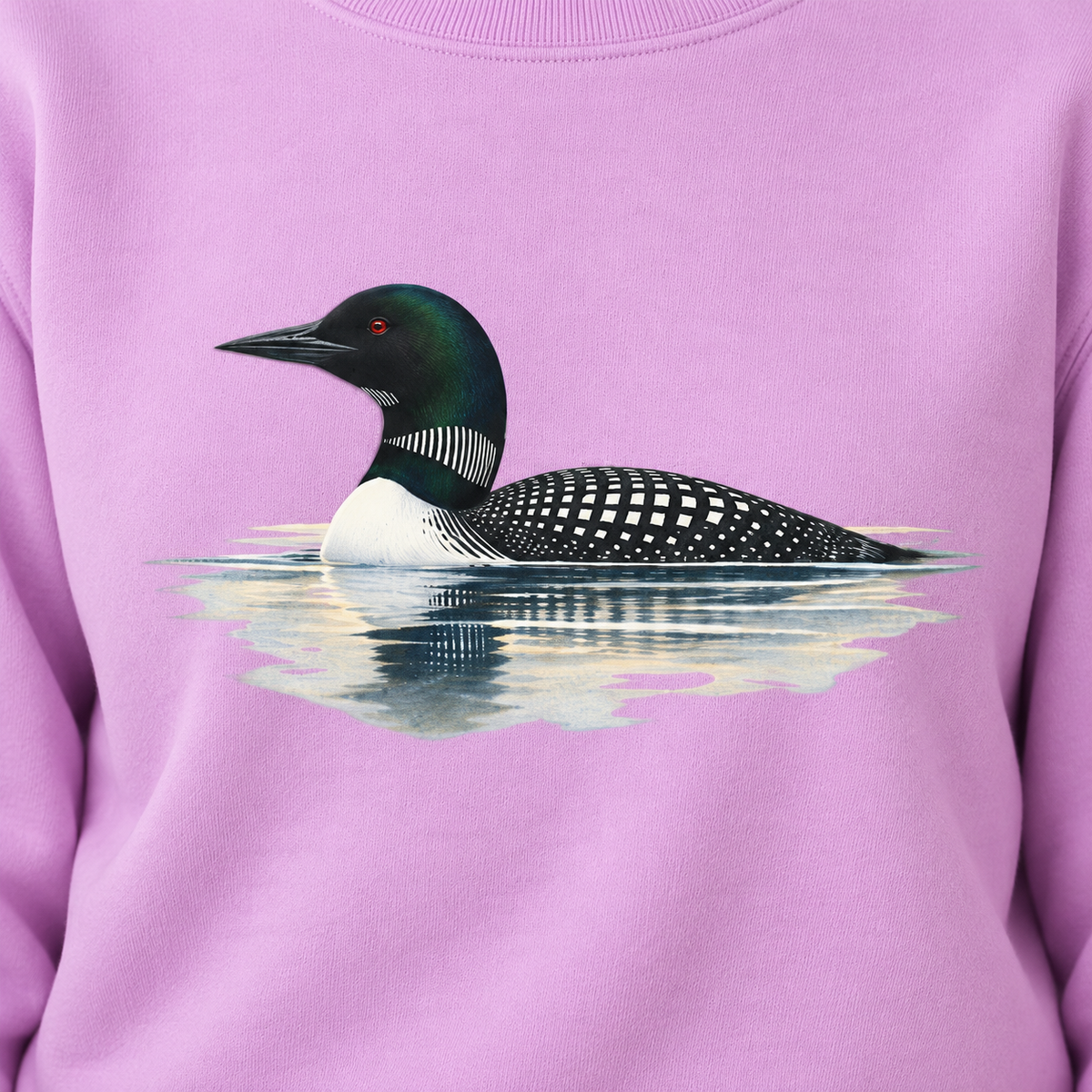 Close-up of the common loon print on an Orchid garment-dyed Comfort Colors sweatshirt - necklace, red eye, checkerboard back and reflection