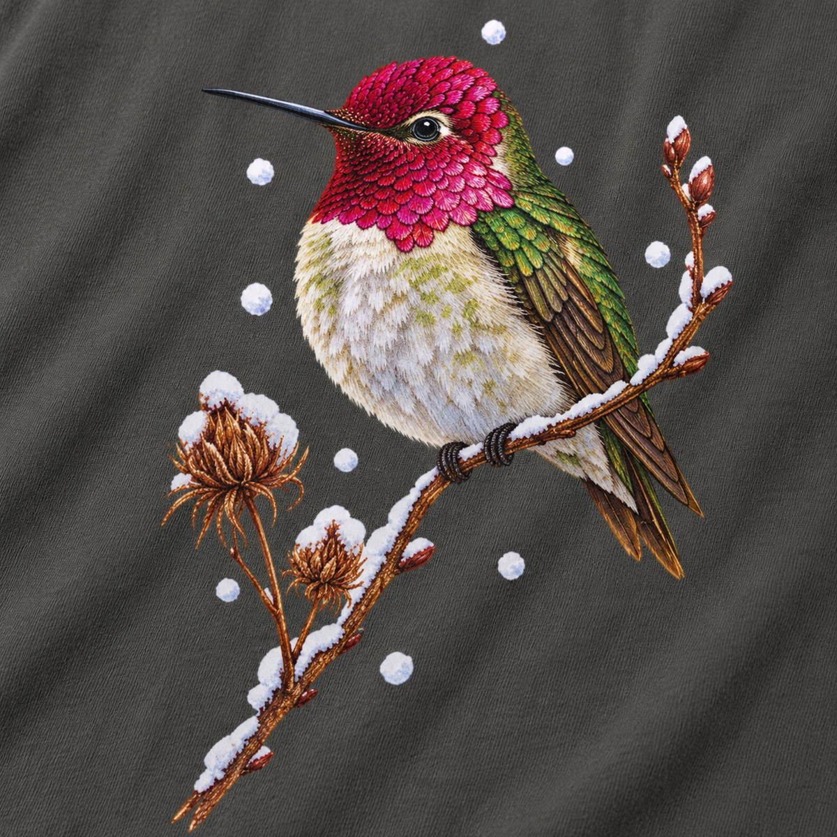 Close-up of the winter hummingbird print on a Pepper Comfort Colors cotton tee - magenta crown and throat, emerald back, snowy twig and seed heads