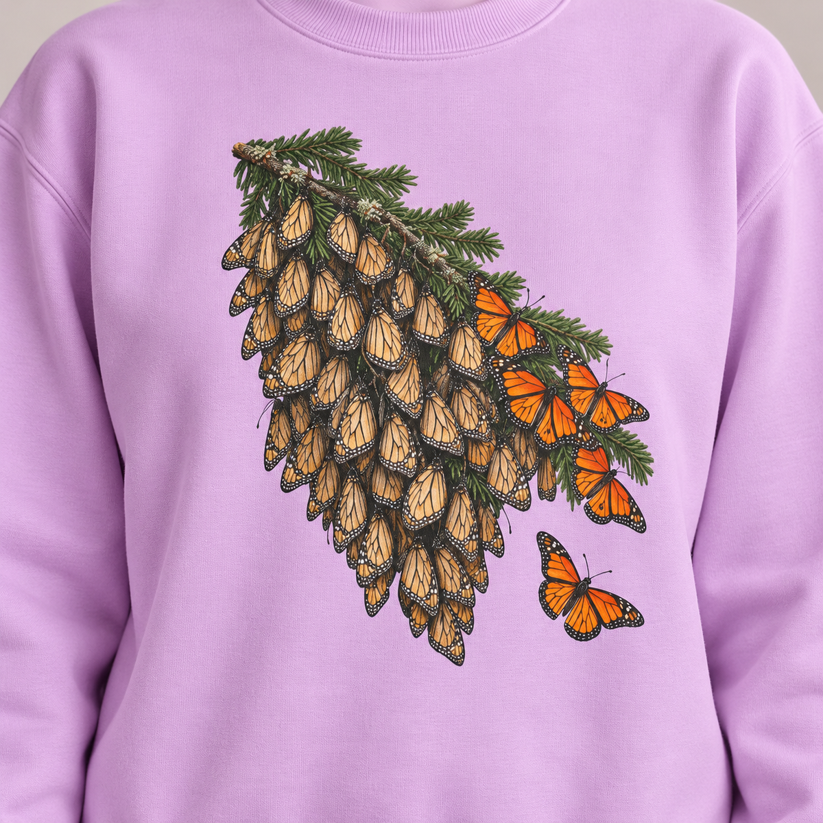 Overwintering Monarchs Sweatshirt in Orchid, worn - a watercolor roost of monarch butterflies on a fir bough on a garment-dyed Comfort Colors crewneck
