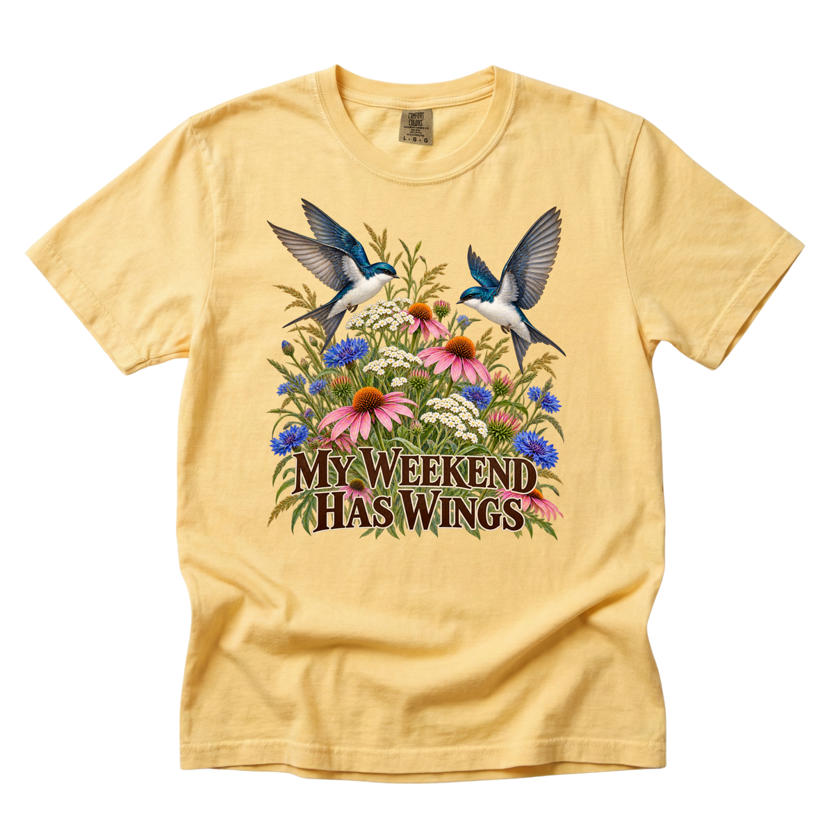 My Weekend Has Wings tee in Butter, two birds sweeping above pink coneflowers and blue wildflowers