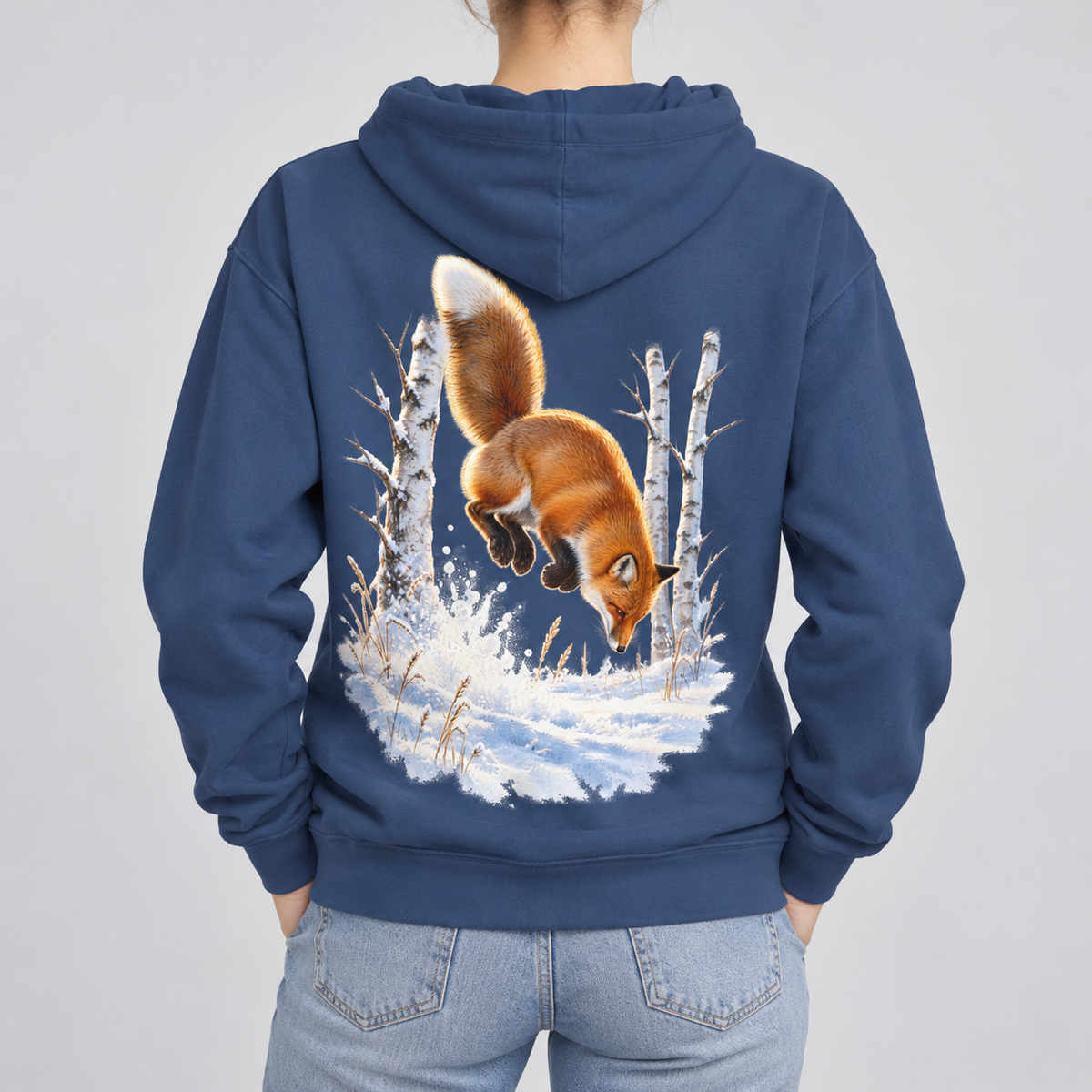 Red Fox Pounce hoodie in True Navy, back view: red fox diving nose-first into snow between birch trees