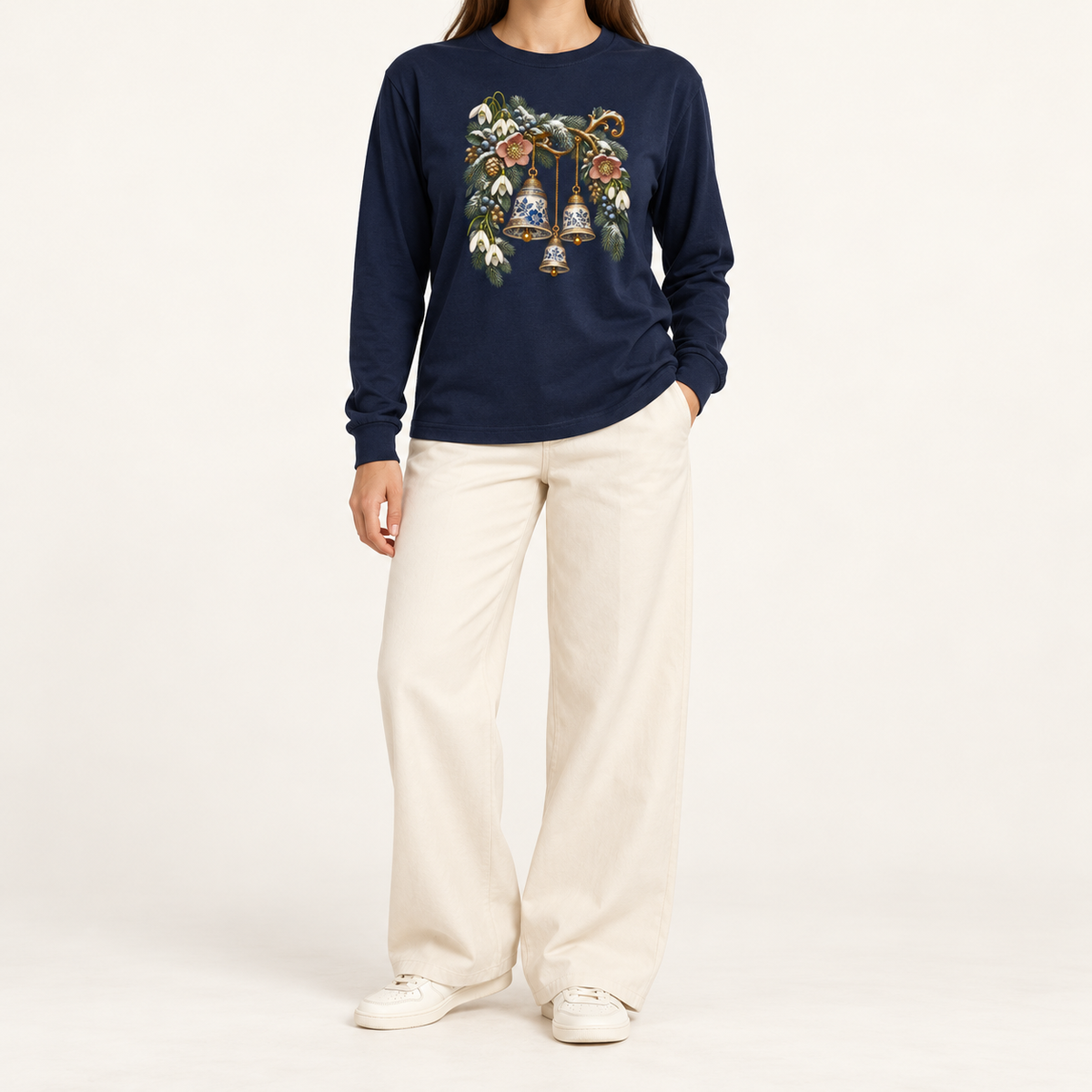 Navy long sleeve tee with a front-centered winter bells print, straight sleeves and ribbed cuffs — blue-and-white porcelain bells among winter botanicals
