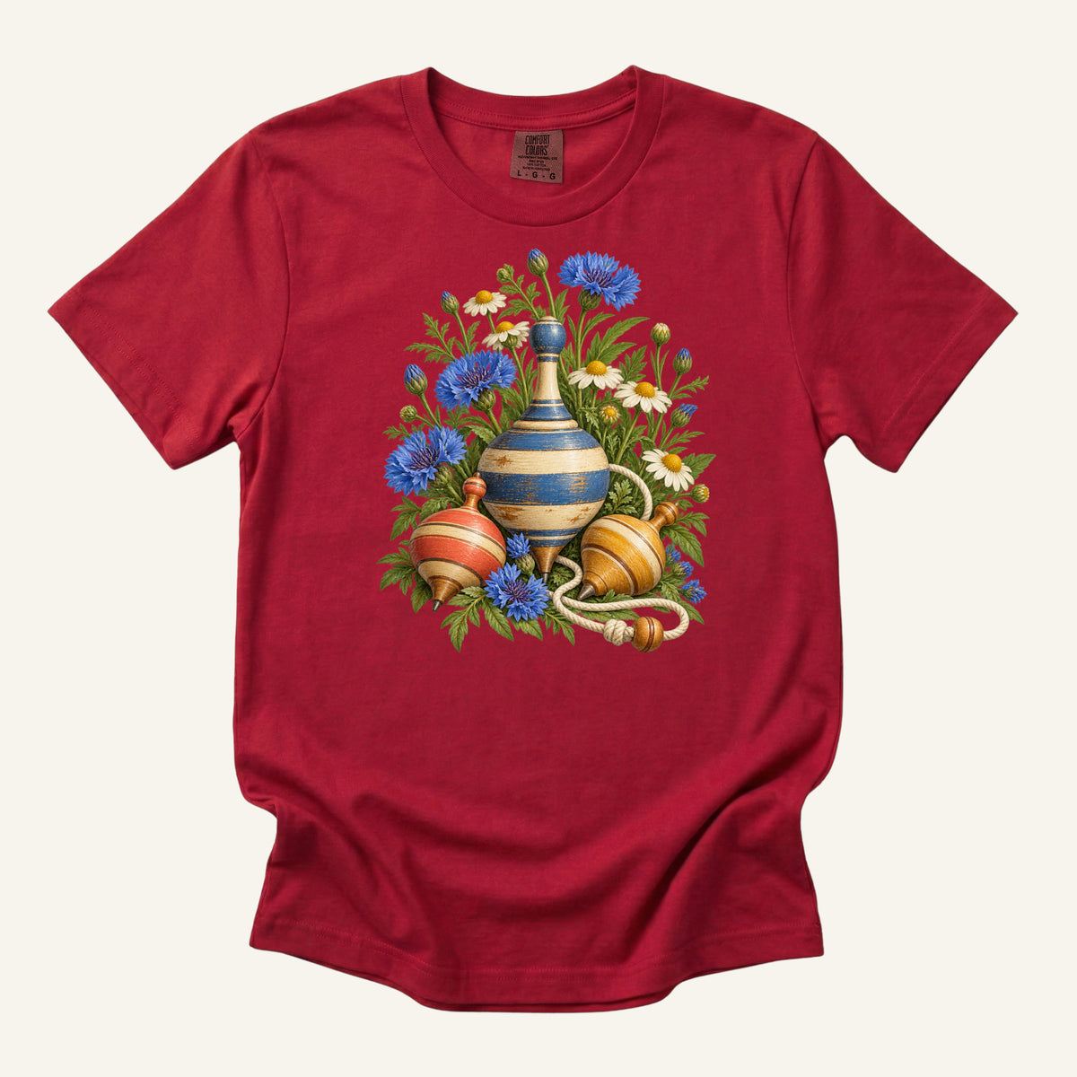 One More Spin T-Shirt in Red — echoing the small red spinning top for a toy-box feel