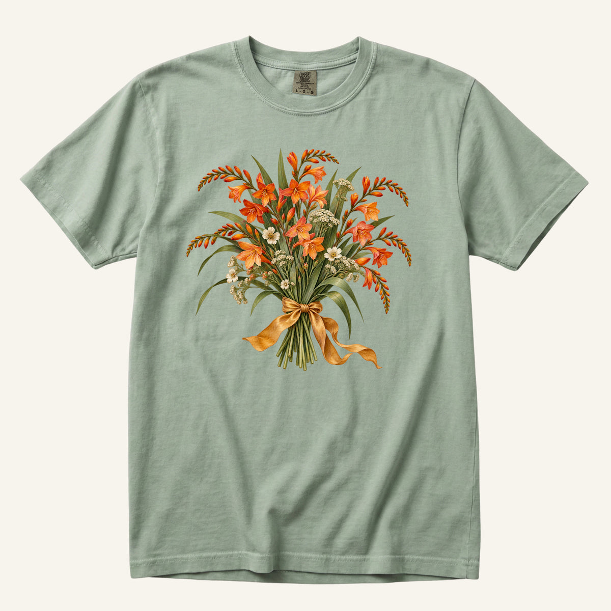 Orange Crocosmia Bouquet T-Shirt in Bay — orange crocosmia and cream flowers tied with a golden ribbon on soft sage green